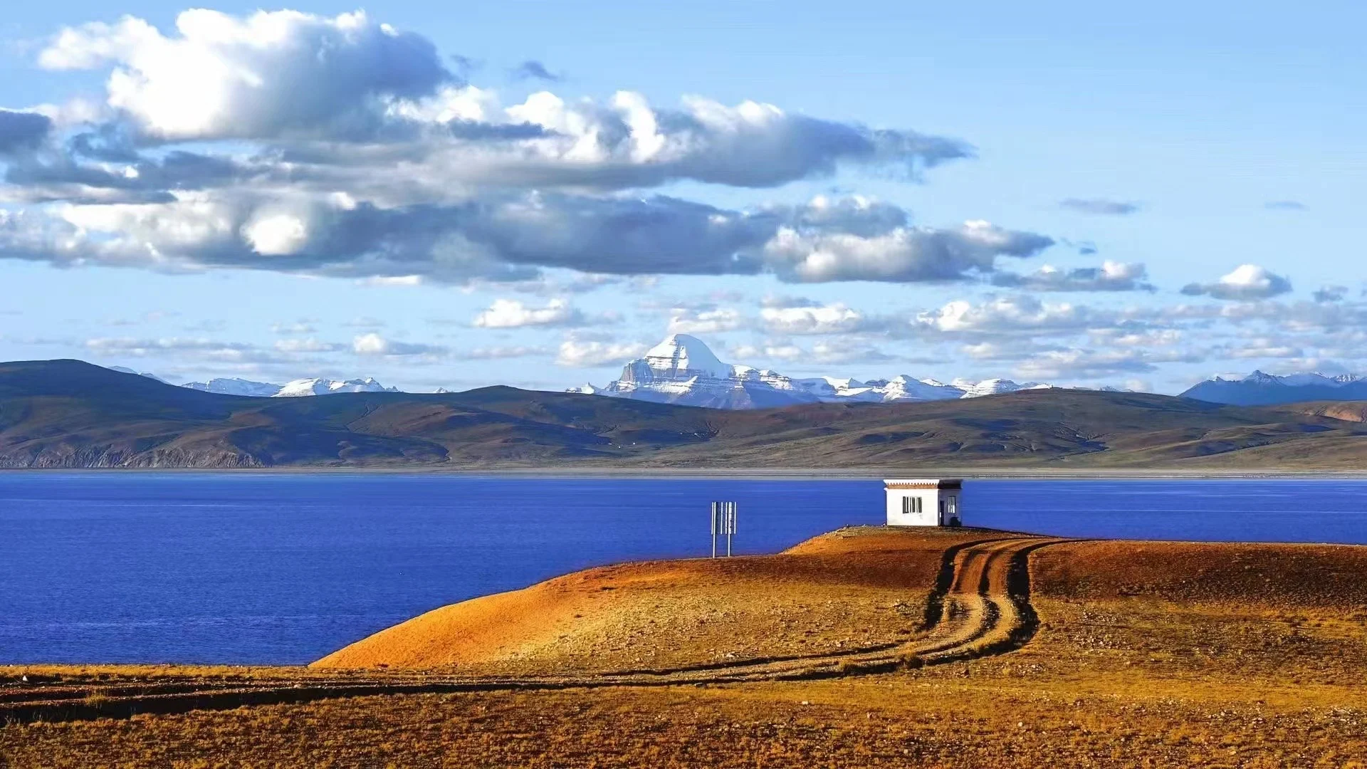 Deep blue lake bordered by a golden shoreline